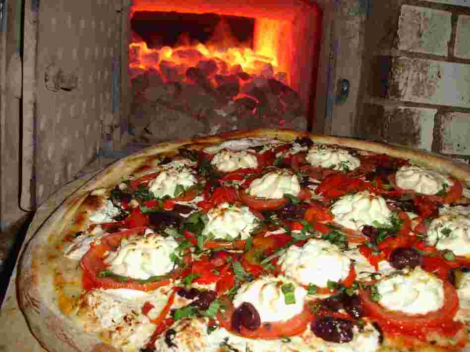 Lombardi's bakes its pizzas in a coal-burning oven. The pizzeria opened its doors in 1905 in Manhattan's Little Italy neighborhood.