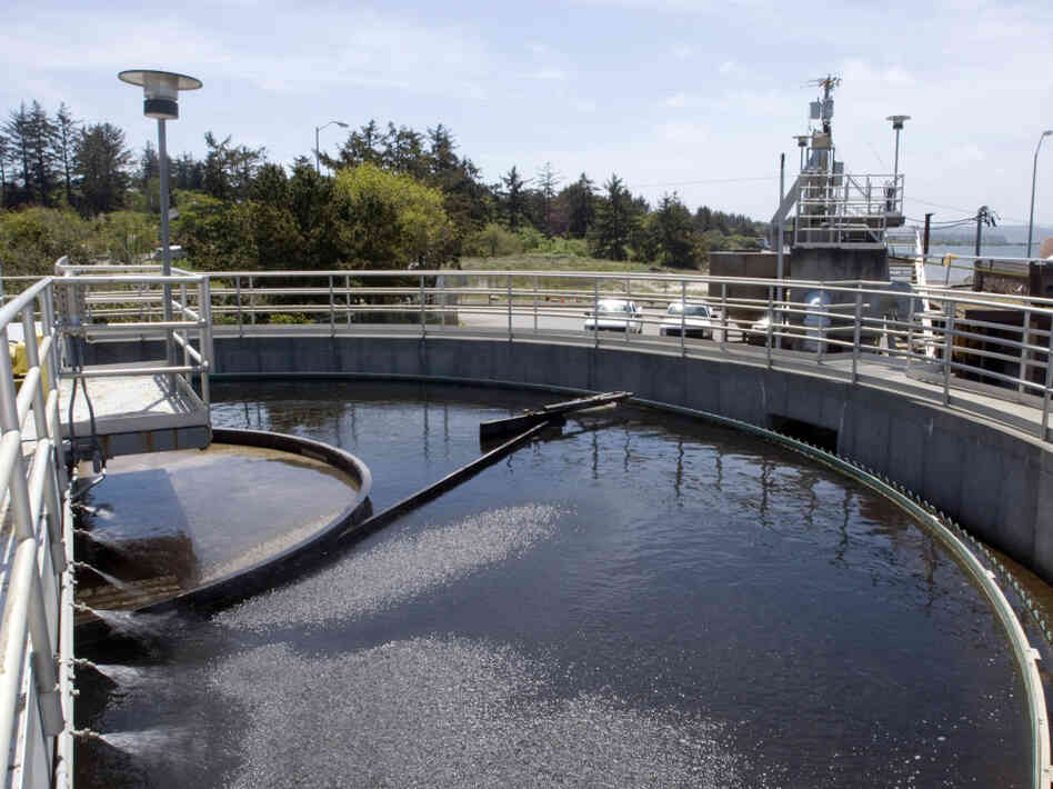 A boom sweeps around a tank at a sewage treatment plant in Coos Bay, Ore. Even though sewage water can be treated and cleaned, psychologists say getting the "cognitive sewage" out of the water is much more difficult.