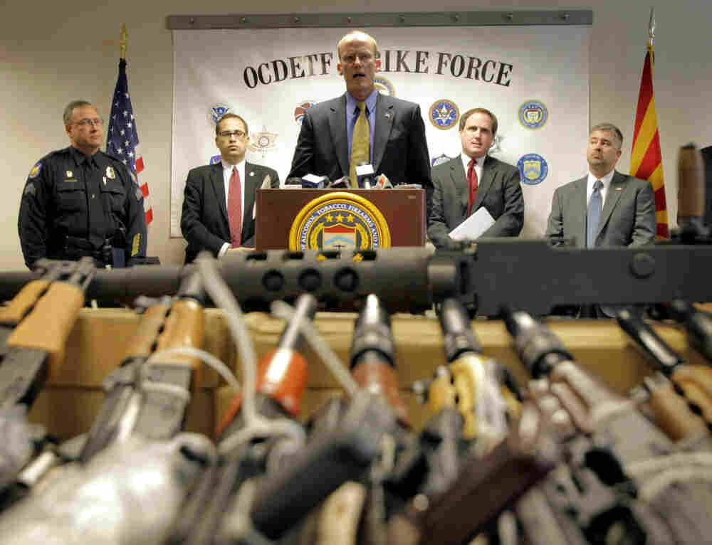 In this Tuesday, Jan. 25, 2011 picture, Bill Newell, special agent in charge of ATF Phoenix, speaks behind a cache of seized weapons in Phoenix. The ATF is under fire over a Phoenix-based gun-trafficking investigation called "Fast and Furious." In this Tuesday, Jan. 25, 2011 picture, Bill Newell, special agent in charge of ATF Phoenix, speaks behind a cache of seized weapons in Phoenix. The ATF is under fire over a Phoenix-based gun-trafficking investigation called "Fast and Furious."