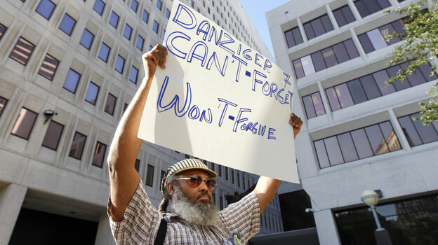 W.C. Johnson, of the group Community United for Change, protests outside federal court in New Orleans on the opening day of the Danziger trial in June. On Aug. 5, five police officers were convicted of various roles in gunning down  innocent civilians in the days after Hurricane Katrina and then  covering it up. Five other officers pleaded guilty.