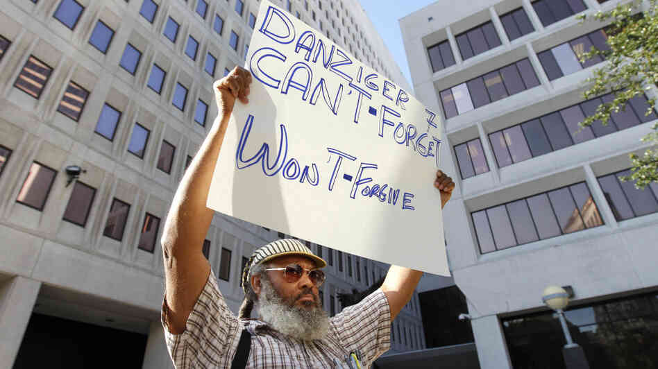 W.C. Johnson, of the group Community United for Change, protests outside federal court in New Orleans on the opening day of the Danziger trial in June. On Aug. 5, five police officers were convicted of various roles in gunning down  innocent civilians in the days after Hurricane Katrina and then  covering it up. Five other officers pleaded guilty.