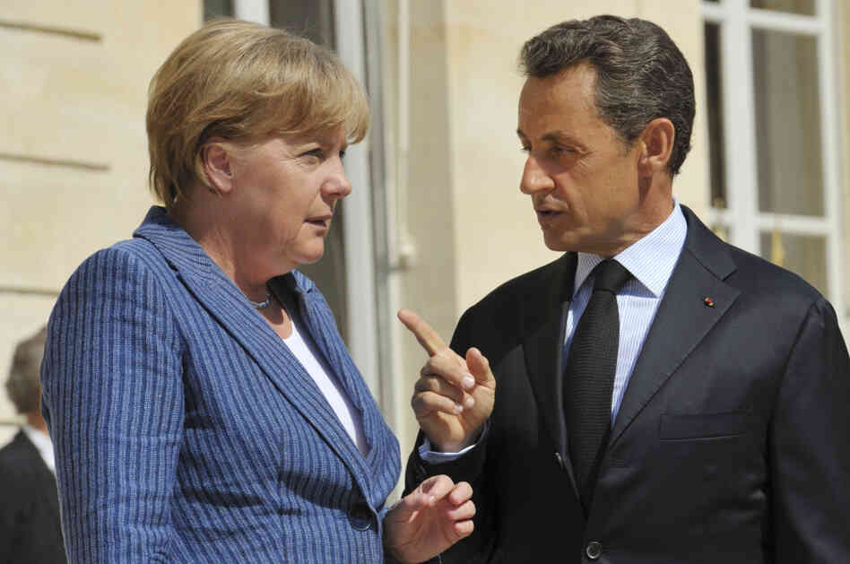 France's President Nicolas Sarkozy, right, speaks to German Chancellor Angela Merkel as he welcomes the German leader at the Elysee Palace in Paris. France's President Nicolas Sarkozy, right, speaks to German Chancellor Angela Merkel as he welcomes the German leader at the Elysee Palace in Paris.