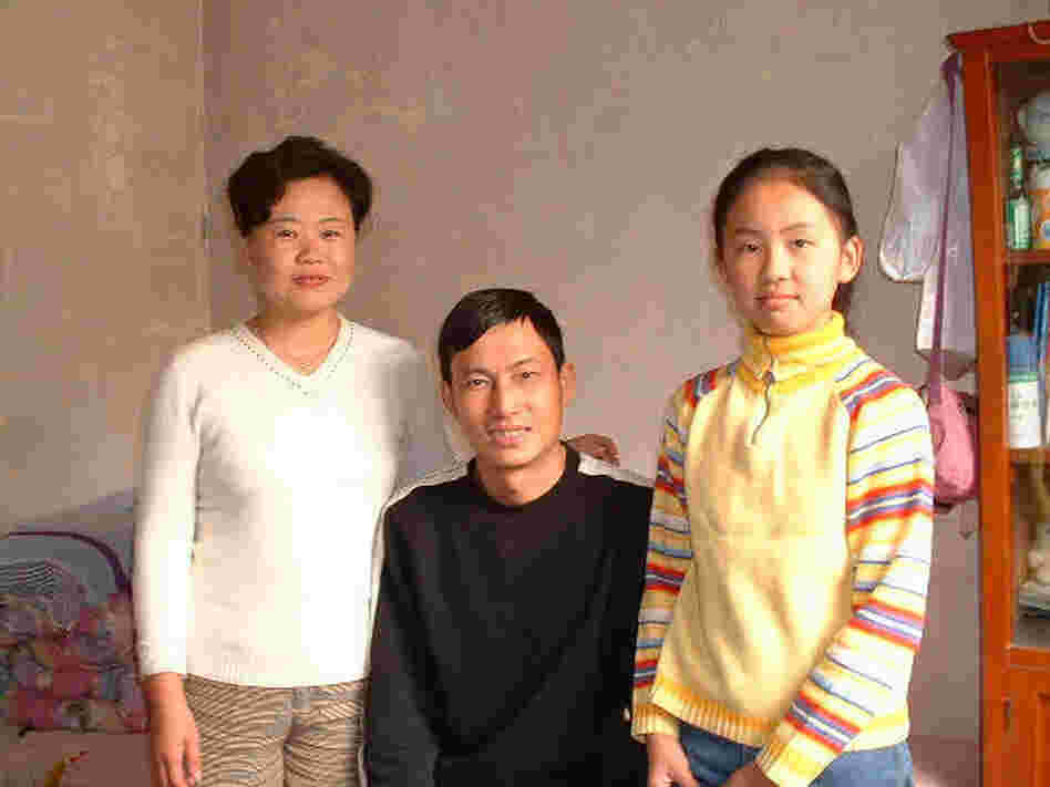 Mandy, age 11, with her  parents in the one-room apartment they shared with her grandmother in Beijing. The room was  about the same size as her freshman double at college last  year.