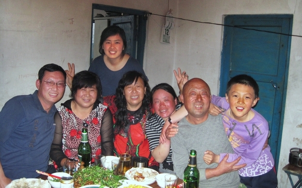 Mandy with her  father  (far left) and other relatives, on her recent trip back to  China.  Her parents think it's important for her to connect with her  relatives, but she  often feels like she doesn't have much to say around  them.