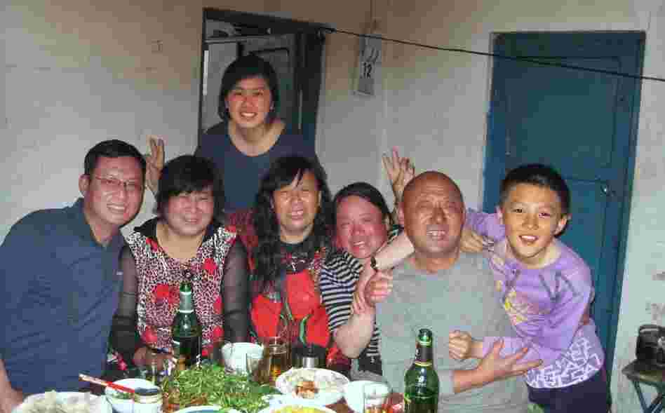 Mandy with her  father  (far left) and other relatives, on her recent trip back to  China.  Her parents think it's important for her to connect with her  relatives, but she  often feels like she doesn't have much to say around  them.