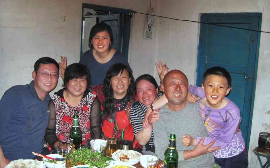 Mandy with her  father  (far left) and other relatives, on her recent trip back to  China.  Her parents think it's important for her to connect with her  relatives, but she  often feels like she doesn't have much to say around  them.
