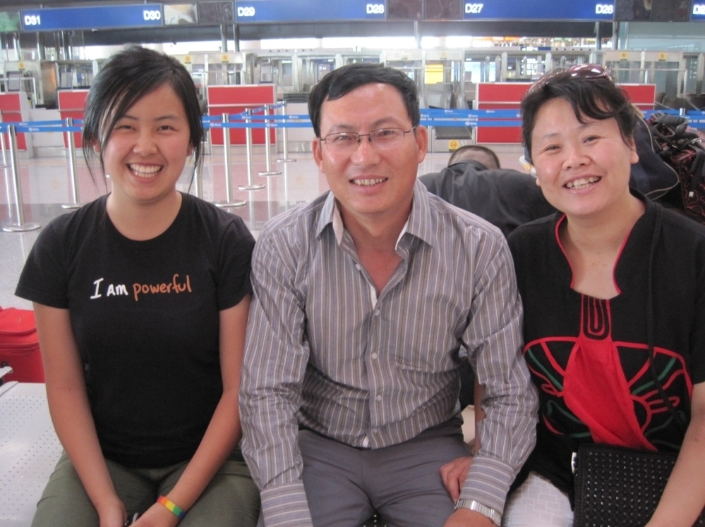 Mandy with her parents at the Beijing airport.