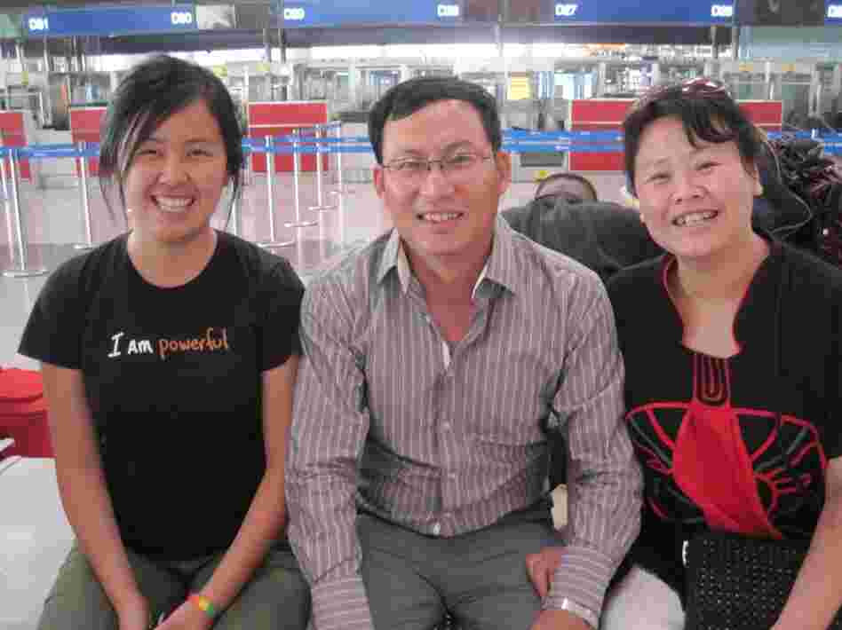 Mandy with her parents at the Beijing airport.