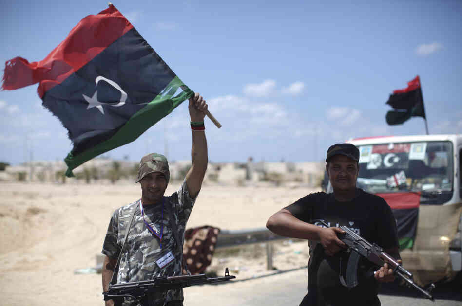 Rebel soldiers pose for photos near the entrance of the town of Brega, Libya. Rebel soldiers pose for photos near the entrance of the town of Brega, Libya.