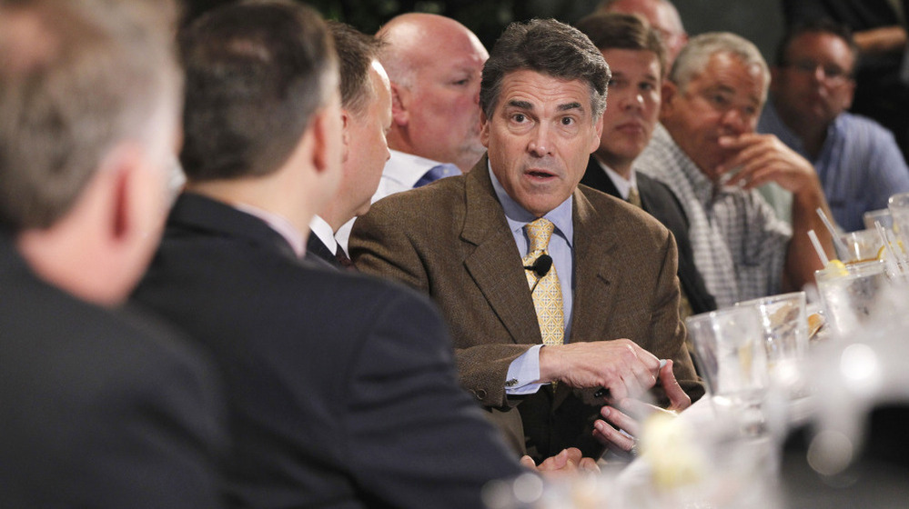 Republican presidential candidate Texas Gov. Rick Perry meets with business leaders at a lunch in Dubuque, Iowa, on Tuesday.