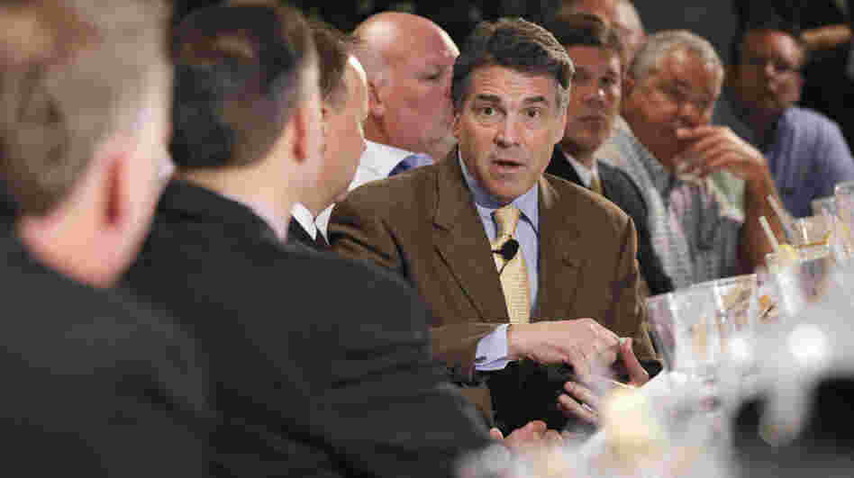 Republican presidential candidate Texas Gov. Rick Perry meets with business leaders at a lunch in Dubuque, Iowa, on Tuesday.