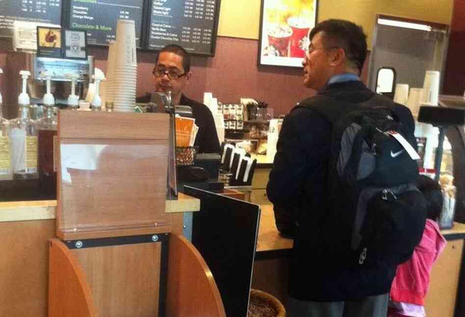 U.S. ambassador to China Gary Locke carries his own backpack and orders his own coffee on Friday Aug. 12 at Seattle-Tacoma International Airport.