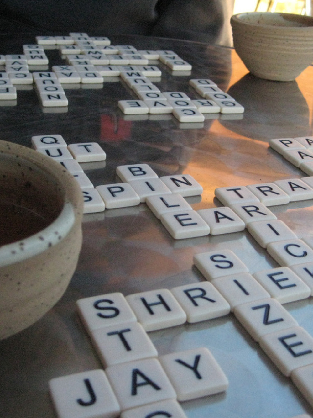 Players form words from a pile of tiles in the center. Once all the tiles have been picked, the first to finish yells "Bananas!"