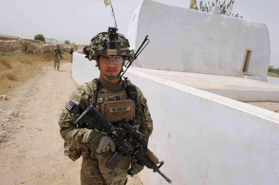 Captain Michael Blakley, company commander of Battle Co., 1-32 Infantry Battalion, 3rd Brigade Combat Team, accompanied by Afghan National Army soldiers leads the patrol at the Mullah Omar mosque in Sangsar village in Kandahar province, the heartland of Taliban in southern Afghanistan.