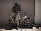 A Libyan rebel fighter leans on a bicycle as he patrols the empty streets of the residential area of the port of Brega Monday. The city represents the eastern front of the rebels' attempt to isolate Moammar Gadhafi in Tripoli. A Libyan rebel fighter leans on a bicycle as he patrols the empty streets of the residential area of the port of Brega Monday. The city represents the eastern front of the rebels' attempt to isolate Moammar Gadhafi in Tripoli.