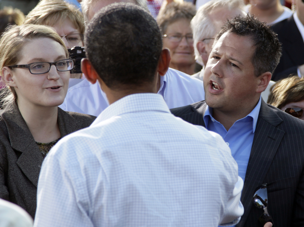 President Obama talks with Ryan Rhodes of the Iowa Tea Party Revolution and an unidentified woman in Decorah, Aug. 15, 2011.