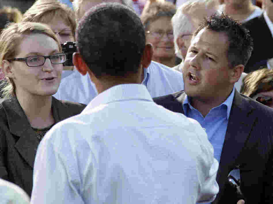 President Obama talks with Ryan Rhodes of the Iowa Tea Party Revolution and an unidentified woman in Decorah, Aug. 15, 2011.
