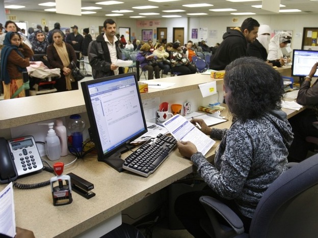 Michigan Department of Human Services caseworker Sandy Satchel works at the Family Independence Agency in Detroit. In the past few years, welfare caseloads have dropped 2 percent in Michigan while unemployment has risen 54 percent, a trend that's reflected in other states.