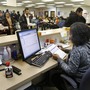 Michigan Department of Human Services caseworker Sandy Satchel works at the Family Independence Agency in Detroit. In the past few years, welfare caseloads have dropped 2 percent in Michigan while unemployment has risen 54 percent, a trend that's reflected in other states.