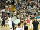 A screengrab from a video shot from the stands shows a Chinese player raising a chair above his head. A screengrab from a video shot from the stands shows a Chinese player raising a chair above his head.