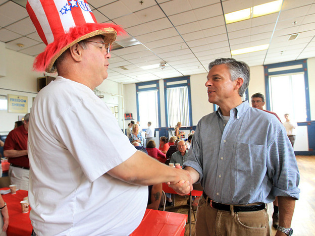 Jon Huntsman, r, shakes a man's hand in Nashua, N.H., Saturday, Aug. 13, 2011.