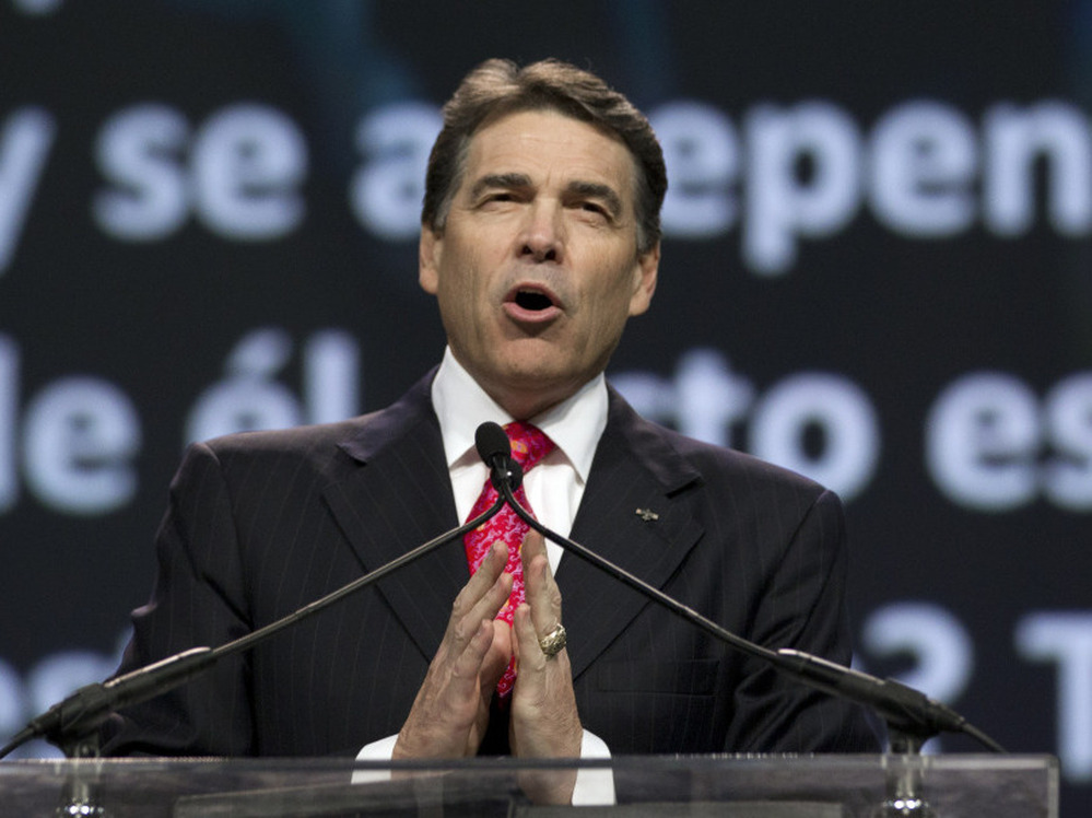 Texas Gov. Rick Perry prays at The Response, his call to prayer for a nation in crisis, on Aug. 6 in Houston. The event was organized, in part, by members of the New Apostolic Reformation.