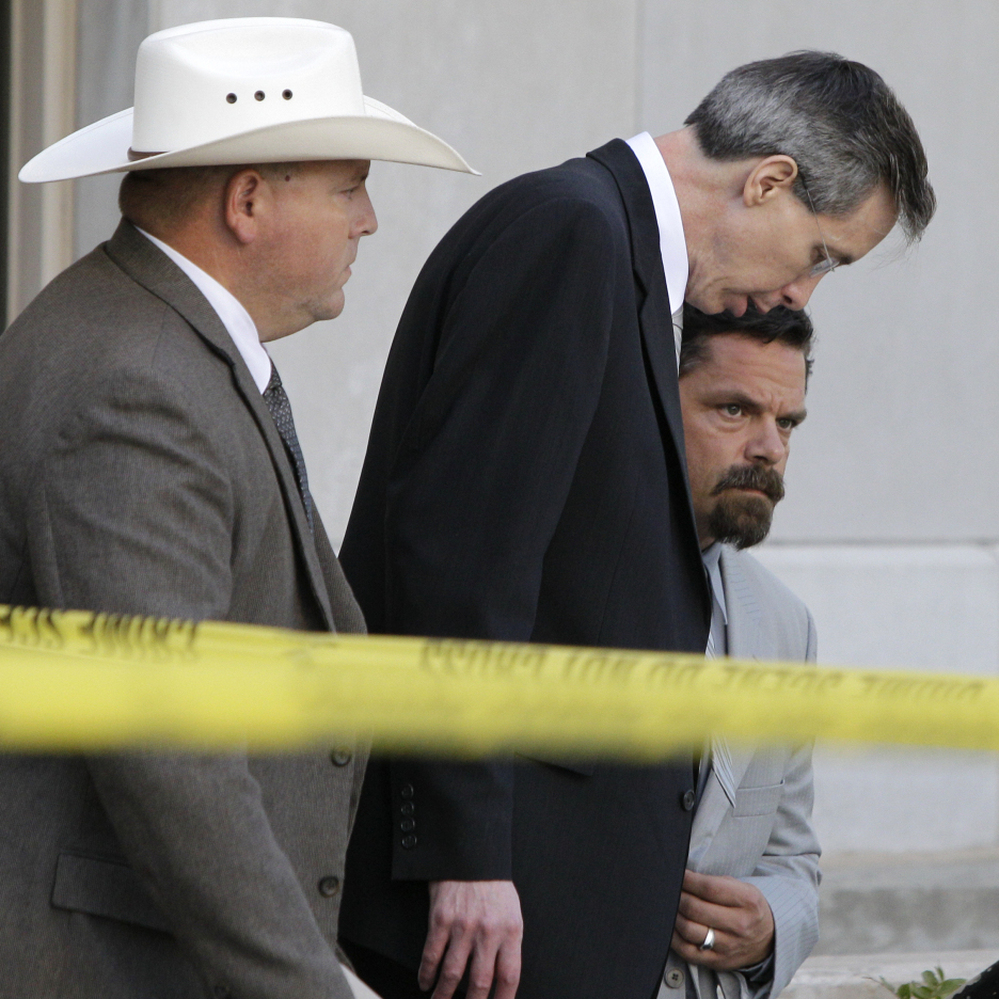 Warren Jeffs, center, leaving a courthouse in San Angelo, Texas, on Aug. 4, 2011.