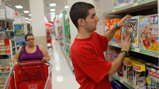 Christian Hernandez stocks shelves earlier this month at a Target store in Miami. Target reported strong profit numbers in the second quarter of 2011 in its continued battle with Walmart stores over discount retail dominance.