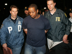 James Cromitie, center, is led by police officers from a federal building in New York, Thursday, May 21, 2009, after being arrested on charges related to a bombing plot in the Bronx. The arrest of Cromitie and three other Muslim ex-convicts in the alleged homegrown terror plot is renewing fears about the spread of Islamic extremism in the nation's prisons. (AP Photo/Robert Mecea)