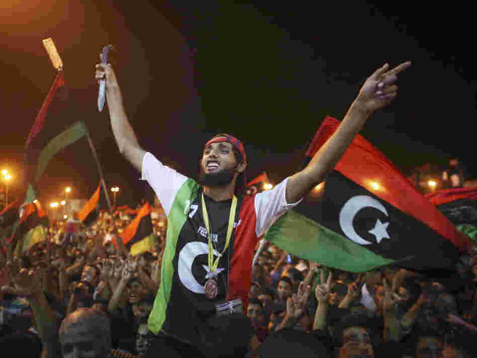 People celebrate the capture in Tripoli of Moammar Gadhafi's son and one-time heir apparent, Seif al-Islam, at the rebel-held town of Benghazi, Libya, early Monday. Libyan rebels raced into Tripoli in a lightning advance Sunday that met little resistance as Gadhafi's defenders melted away and his 42-year rule appeared to rapidly crumble.