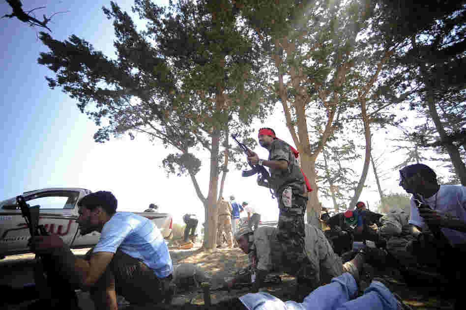 Rebels take position during fighting against regime forces west of Tripoli. 