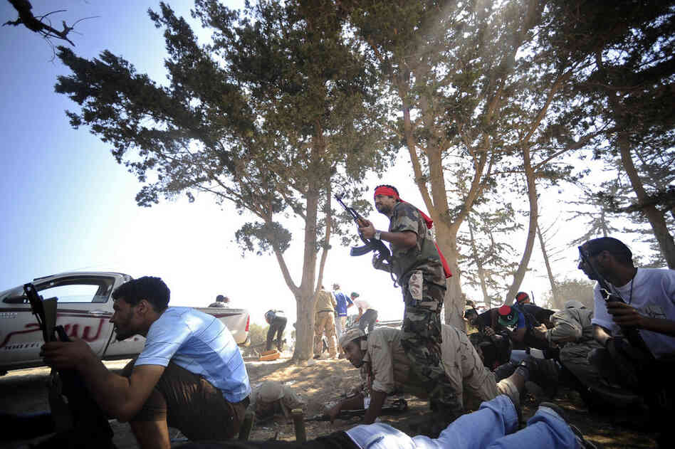 Rebels take position during fighting against regime forces west of Tripoli, on Sunday. 