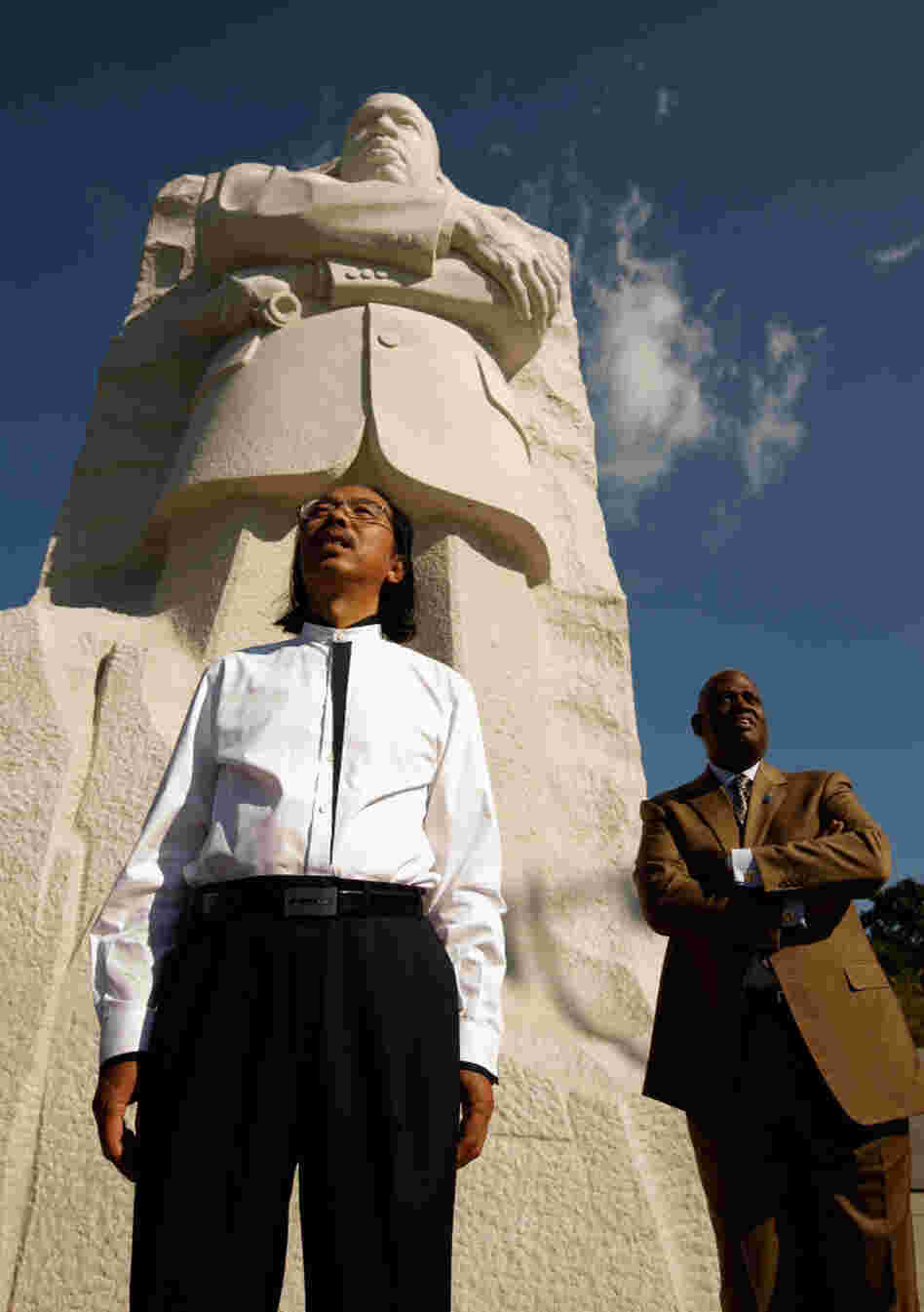 Master Sculptor Lei Yixin and Harry Johnson, president and CEO of the Martin Luther King Jr. National Memorial Project Foundation, stand at the base of the 30-feet-tall sculpture at the new King memorial.