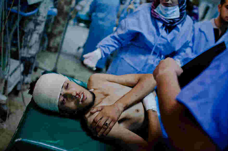 A Libyan rebel fighter receives medical attention after being brought in with a gunshot wound to his head at the Tripoli Central Hospital. 