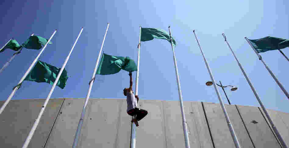 Libyan rebels remove the green flags from poles at the Abu Salim square in Tripoli on Aug. 26 after the opposition forces announced the transfer of their leadership to the capital. 