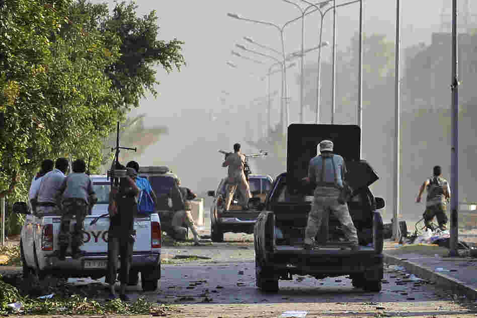 Rebel fighters advance toward the frontline in the Abu Salim district. 