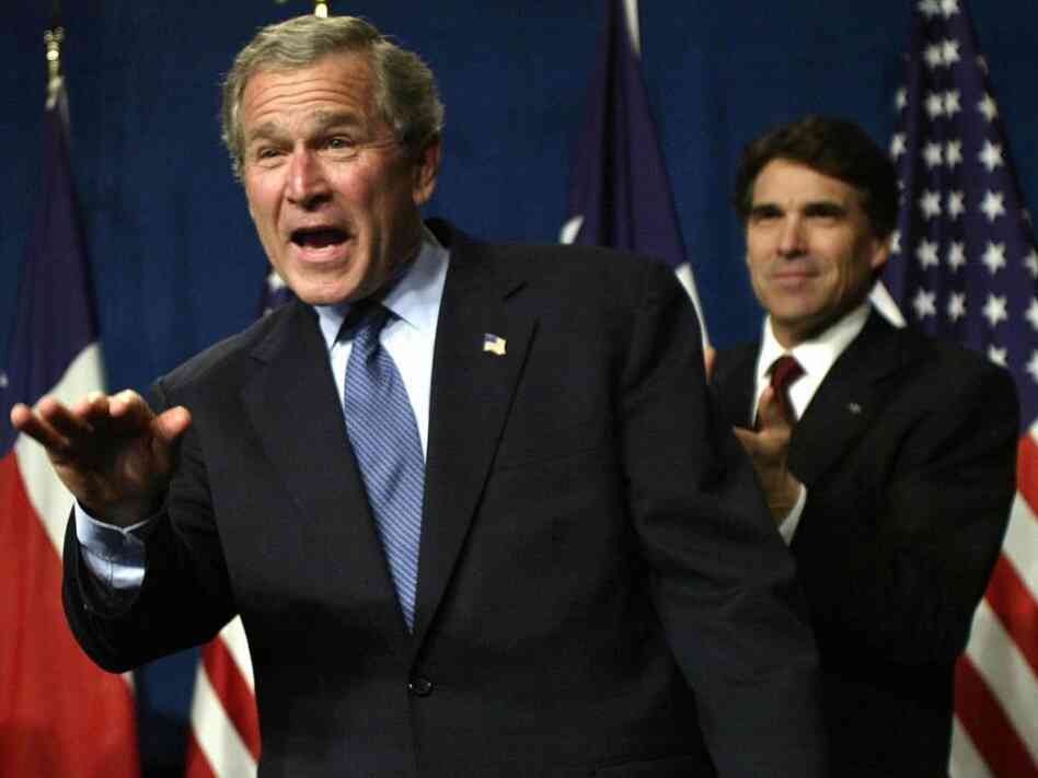 Then President George W. Bush waves as he takes the stage during a Bush-Cheney 2004 reception with Texas Governor Rick Perry at the Hilton Americas  in March 2004 in Houston, Texas. Perry is now considered a front runner for the 2012 GOP presidential nomination.