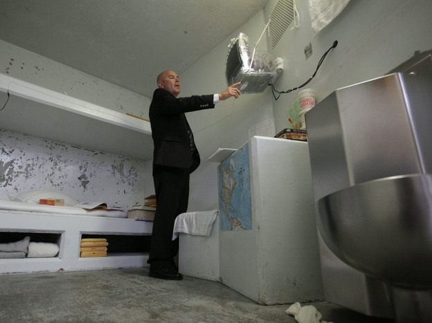 Correctional Officer Lt. Christopher Acosta  turns on a television in a cell in the Secure Housing Unit at Pelican Bay State Prison near Crescent City, Calif., on Aug. 17.  State prison officials allowed the media to tour Pelican Bay's SHU, where inmates are isolated.