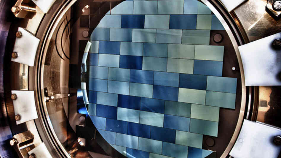 A look inside the Dark Energy Camera shows the 74 blue-tinged sensors that detect light. The camera will survey distant, faint galaxies to learn more about dark energy. A look inside the Dark Energy Camera shows the 74 blue-tinged sensors that detect light. The camera will survey distant, faint galaxies to learn more about dark energy.