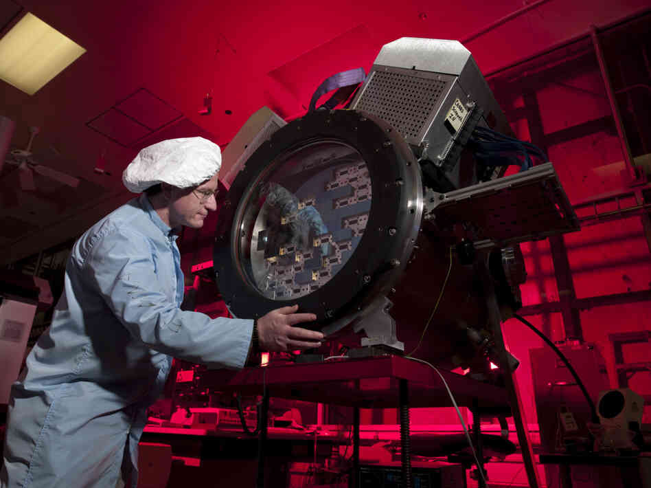 Fermilab scientist Tom Diehl works on the heart of the Dark Energy Camera.