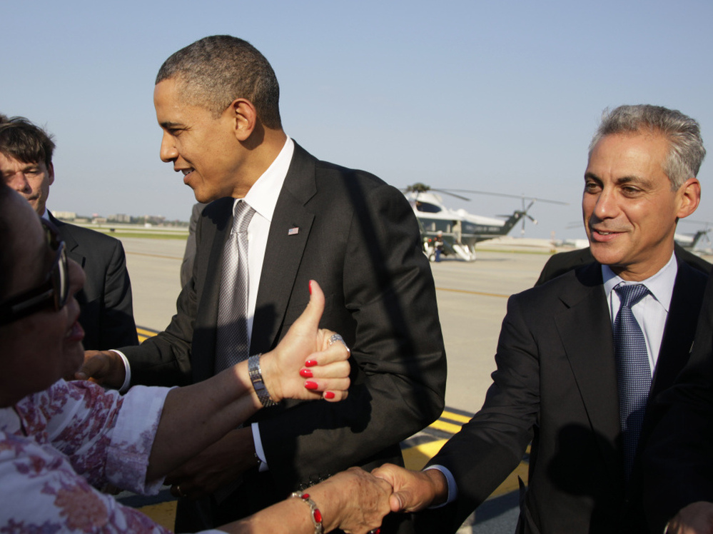 Emanuel and President Obama greet people on the tarmac as the president arrives at Chicago's O'Hare International Airport earlier this month. Emanuel still informally advises the president but says he has no regrets leaving the White House.