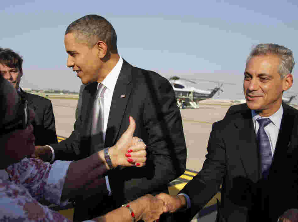 Emanuel and President Obama greet people on the tarmac as the president arrives at Chicago's O'Hare International Airport earlier this month. Emanuel still informally advises the president but says he has no regrets leaving the White House.