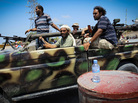 Libyan rebel fighters sped towards the front line of fighting in the village of Al-Mayah, just west of Tripoli, on Sunday. Libyan rebel fighters sped towards the front line of fighting in the village of Al-Mayah, just west of Tripoli, on Sunday.