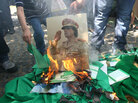 A portrait of Libyan leader Moammar Gadhafi and copies of his green book are set on fire by demonstrators during a protest outside the Libyan embassy in Ankara on August 22, 2011 as Libyan rebels entered the heart of Tripoli in a final drive to oust Kadhafi. A portrait of Libyan leader Moammar Gadhafi and copies of his green book are set on fire by demonstrators during a protest outside the Libyan embassy in Ankara on August 22, 2011 as Libyan rebels entered the heart of Tripoli in a final drive to oust Kadhafi.