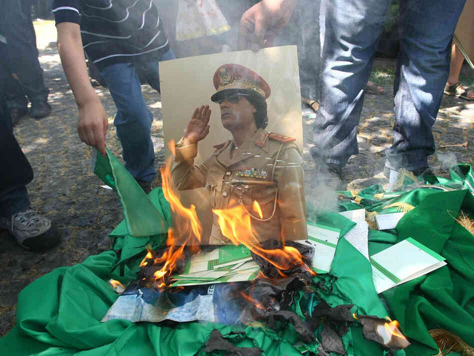 A portrait of Libyan leader Moammar Gadhafi and copies of his green book are set on fire by demonstrators during a protest outside the Libyan embassy in Ankara on August 22, 2011 as Libyan rebels entered the heart of Tripoli in a final drive to oust Kadhafi. A portrait of Libyan leader Moammar Gadhafi and copies of his green book are set on fire by demonstrators during a protest outside the Libyan embassy in Ankara on August 22, 2011 as Libyan rebels entered the heart of Tripoli in a final drive to oust Kadhafi.