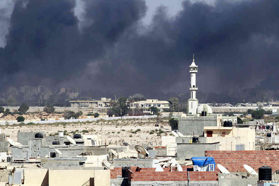 Smoke rises above downtown Tripoli near fighting at Gadhafi's compound. 
