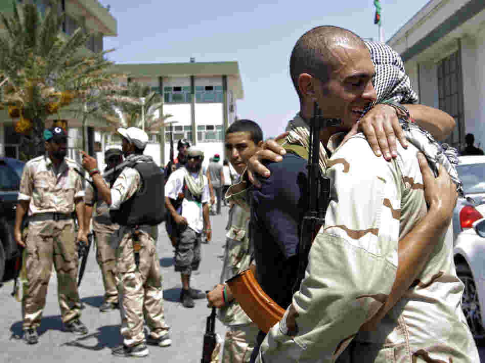 Libyan rebels embraced Monday at the former female military base in Tripoli after opposition fighters raced into the capital in a lightning advance the day before.