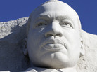 The statue of Dr. Martin Luther King, Jr. is seen unveiled from scaffolding during the soft opening of the Martin Luther King, Jr. Memorial in Washington on Monday. The statue of Dr. Martin Luther King, Jr. is seen unveiled from scaffolding during the soft opening of the Martin Luther King, Jr. Memorial in Washington on Monday.