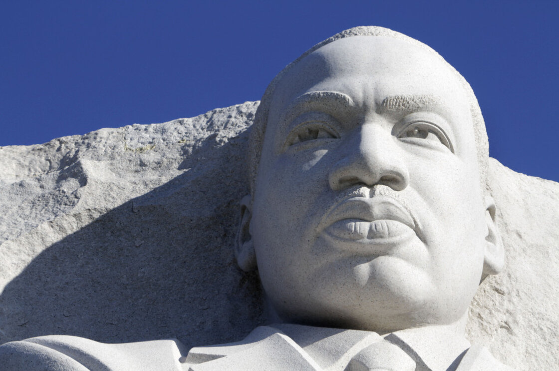 The statue of Dr. Martin Luther King, Jr. is seen unveiled from scaffolding during the soft opening of the Martin Luther King, Jr. Memorial in Washington on Monday.