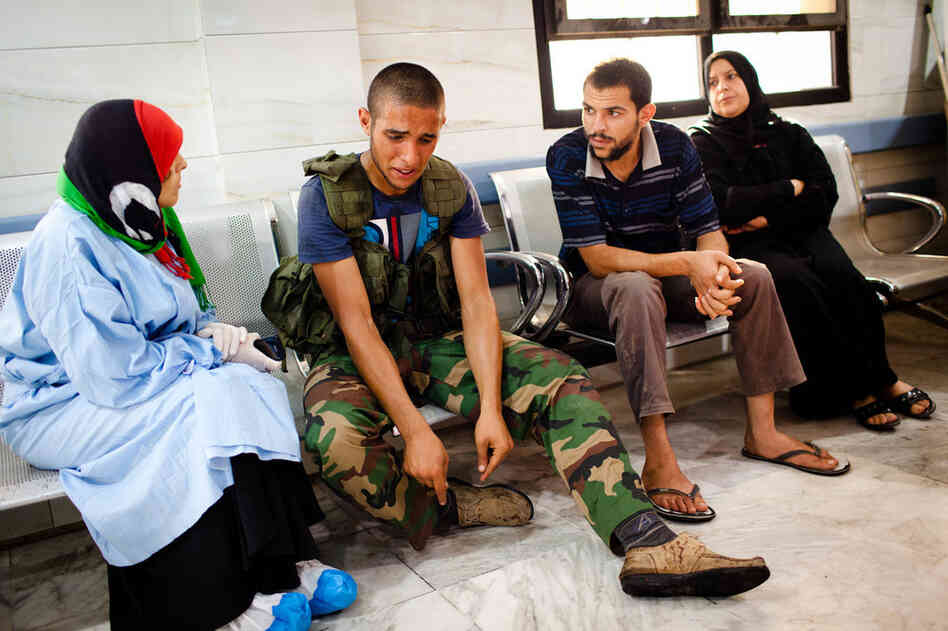 A rebel soldier reacts after a fellow fighter was brought in with a wound sustained in battle with fighters loyal to longtime leader Moammar Gadhafi at Tripoli Central Hospital. 